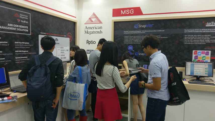 Group of people interacting with AMI booth